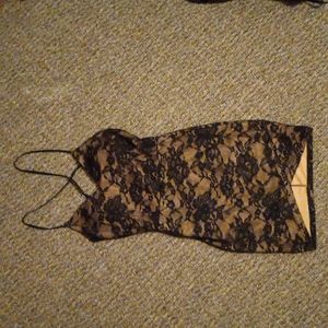 Black and nude lacy party dress. With criss cross straps.
